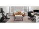 Home office or gym with a desk, exercise bike, and comfortable seating at 2535 Grayton Loop, Villa Rica, GA 30180