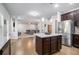 Open kitchen features an island, stainless steel appliances, and hardwood floors at 2535 Grayton Loop, Villa Rica, GA 30180