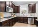 Kitchen with dark cabinets, granite countertops, and stainless steel appliances at 2535 Grayton Loop, Villa Rica, GA 30180
