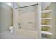 Bathroom with full tub/shower combination and storage shelves at 3208 Paddock Rd, Covington, GA 30014