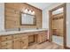 The bathroom features double sinks, wood accent wall, tile floor, and access to closet at 3208 Paddock Rd, Covington, GA 30014