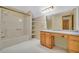 Bathroom with full tub/shower combination, large mirror, and built-in vanity at 3208 Paddock Rd, Covington, GA 30014