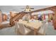 Open-concept dining room with wooden table and seating, seamlessly connected to the living area and kitchen at 3208 Paddock Rd, Covington, GA 30014