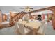 Open-concept dining room with wooden table and seating, seamlessly connected to the living area and kitchen at 3208 Paddock Rd, Covington, GA 30014
