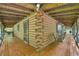 Spacious porch of a log cabin featuring a wooden swing, offering a relaxing outdoor space at 3208 Paddock Rd, Covington, GA 30014