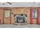 Rustic stone fireplace in a cozy room with wood paneled walls, creating a warm and inviting atmosphere at 3208 Paddock Rd, Covington, GA 30014