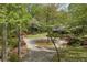 Beautifully landscaped log home exterior with circular driveway and mature trees at 3208 Paddock Rd, Covington, GA 30014