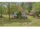 Charming log home with inviting porch and lush landscaping at 3208 Paddock Rd, Covington, GA 30014