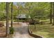 Secluded log home featuring a landscaped front yard and a winding driveway, surrounded by lush trees at 3208 Paddock Rd, Covington, GA 30014