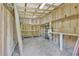 Interior view of a shed with shelving and a dirt floor, ideal for storage and workshop activities at 3208 Paddock Rd, Covington, GA 30014