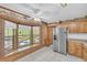Spacious kitchen with stainless refrigerator and a bay window overlooking the yard at 3208 Paddock Rd, Covington, GA 30014