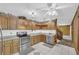 Cozy kitchen featuring knotty pine cabinets, tile floor, and modern stainless steel appliances at 3208 Paddock Rd, Covington, GA 30014