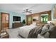 Warm, inviting main bedroom featuring wood accent wall, soft decor, and sitting area at 3208 Paddock Rd, Covington, GA 30014