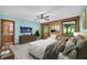 Relaxing main bedroom features wooden accent wall, mounted television, and ceiling fan at 3208 Paddock Rd, Covington, GA 30014