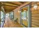 Inviting covered porch with a wooden bench and a clear view through the decorative glass front door at 3208 Paddock Rd, Covington, GA 30014