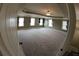 Spacious carpeted bonus room illuminated by natural light from multiple windows, perfect for entertaining at 2616 Holden Spring Dr, Dacula, GA 30019