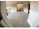 Upstairs bonus area with neutral walls, carpet, and lots of sunlight, ideal for a play or study area at 2616 Holden Spring Dr, Dacula, GA 30019