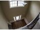 Dramatic aerial view of a foyer with hard wood flooring, a pendant light, and staircase to the second level at 2616 Holden Spring Dr, Dacula, GA 30019