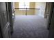 Upstairs hallway with carpet, decorative iron railing and views of the exterior at 2616 Holden Spring Dr, Dacula, GA 30019