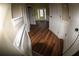 Hallway with hardwood flooring and decorative wall paneling leading to the foyer with lots of natural light at 2616 Holden Spring Dr, Dacula, GA 30019
