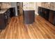A kitchen showcases dark cabinets, an island, stainless steel appliances, and granite countertops at 2616 Holden Spring Dr, Dacula, GA 30019