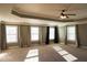Spacious main bedroom boasts tray ceilings, large windows, and elegant curtains at 2616 Holden Spring Dr, Dacula, GA 30019