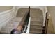 A carpeted staircase with a decorative wood and iron railing and chair rail molding at 2616 Holden Spring Dr, Dacula, GA 30019