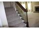 Carpeted staircase with dark wood railing and wrought iron spindles leading to upper level at 2616 Holden Spring Dr, Dacula, GA 30019
