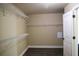 A walk-in closet with built-in shelving and wood-look floor in the closet at 2616 Holden Spring Dr, Dacula, GA 30019