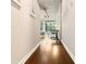Hallway with hardwood floors leading to a living space and a large window at 923 Peachtree Ne St # 927, Atlanta, GA 30309