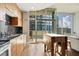 Sunlit kitchen with wood cabinets, stainless appliances, and an adjacent balcony overlooking the cityscape at 923 Peachtree Ne St # 927, Atlanta, GA 30309