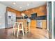 Bright kitchen with stainless steel appliances, wood cabinets, and a kitchen island with seating at 923 Peachtree Ne St # 927, Atlanta, GA 30309