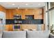 Modern kitchen with stainless steel appliances, wood cabinets, and a kitchen island with seating at 923 Peachtree Ne St # 927, Atlanta, GA 30309