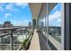 Enjoy city views from this condo balcony with glass railings and an overlooking pool on a bright day at 1065 Peachtree Ne St # 3003, Atlanta, GA 30309