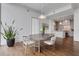 Dining area featuring modern table set with hardwood floors, light walls, and open kitchen access at 1065 Peachtree Ne St # 3003, Atlanta, GA 30309