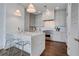 Modern kitchen features marble countertops, stainless steel appliances, white cabinetry, and bar seating at 1065 Peachtree Ne St # 3003, Atlanta, GA 30309
