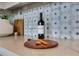 Close-up of kitchen countertop with wine, glass, crackers, and flower patterned backsplash tiles at 1065 Peachtree Ne St # 3003, Atlanta, GA 30309