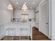 Well-lit kitchen features marble countertops, stainless steel appliances, white cabinets, and two bar stools at 1065 Peachtree Ne St # 3003, Atlanta, GA 30309