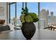 Living room accent featuring dining table with floral arrangement and city view at 1065 Peachtree Ne St # 3003, Atlanta, GA 30309