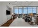 Bright living room with hardwood floors, large windows, and city views at 1065 Peachtree Ne St # 3003, Atlanta, GA 30309