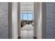 View of a modern living room through an open doorway, featuring large windows with city views and stylish decor at 1065 Peachtree Ne St # 3003, Atlanta, GA 30309