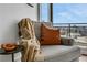 Cozy sitting area featuring a comfortable chair with a throw blanket, side table, and city views at 1065 Peachtree Ne St # 3003, Atlanta, GA 30309