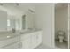 Bright bathroom with double sinks, white cabinets, large mirror, and separate toilet room at 2029 Memorial Dr # 34, Atlanta, GA 30317