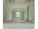 Bathroom featuring a double vanity with white cabinets and a large rectangular mirror above at 2029 Memorial Dr # 34, Atlanta, GA 30317