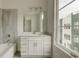 Bright bathroom features a vanity with sink, large window, tub and shower combination with tile surround at 2029 Memorial Dr # 34, Atlanta, GA 30317