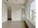 Bedroom featuring wood floors, white walls, large window with exterior view, and attached bathroom at 2029 Memorial Dr # 34, Atlanta, GA 30317