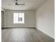 Bedroom features hardwood floors, white walls, a modern ceiling fan, and a view to the exterior at 2029 Memorial Dr # 34, Atlanta, GA 30317