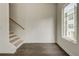 Light-filled entryway featuring hardwood floors, stairs with wooden handrail, and a large window at 2029 Memorial Dr # 34, Atlanta, GA 30317