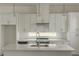 Modern kitchen with white cabinets, island with sink, and stainless steel appliances at 2029 Memorial Dr # 34, Atlanta, GA 30317