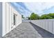 Spacious rooftop deck with gray tiles and a white privacy fence, offering a great outdoor space at 2029 Memorial Dr # 34, Atlanta, GA 30317